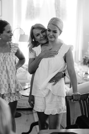 Black and white candid moments captured during wedding preparations.