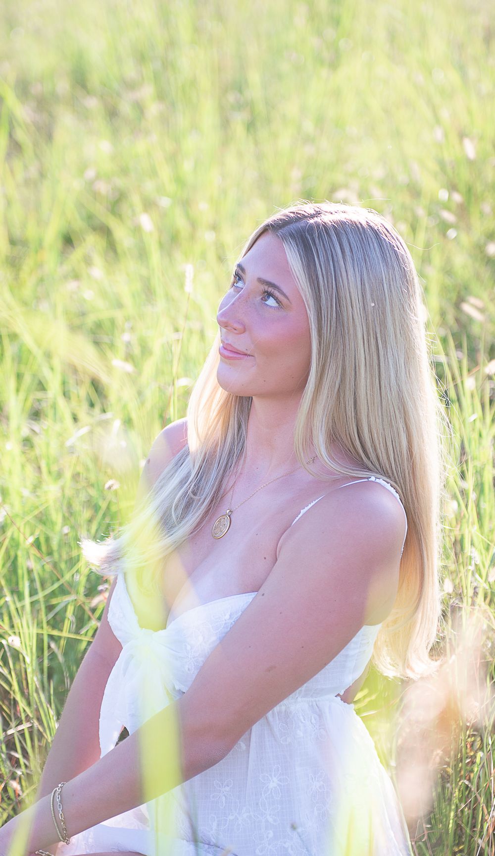 Artistic portrait sequence in golden light showing joyful expressions and flowing blonde hair against tall grass.