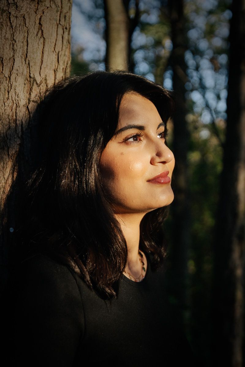 Dramatic close-up profile shots with natural forest lighting and dark contrasts.