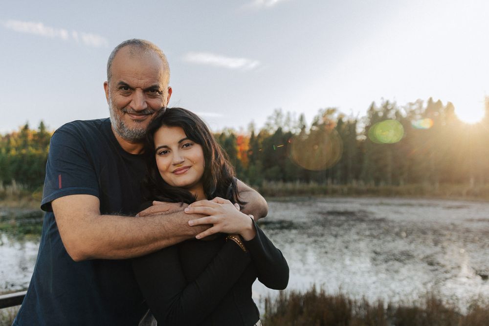 Intimate outdoor portraits of a couple sharing tender moments by the water at sunset.