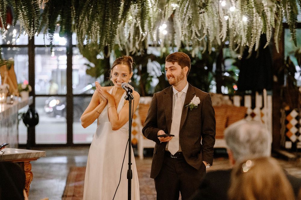 A romantic wedding ceremony setup with hanging floral decorations and soft lighting creating an intimate atmosphere.