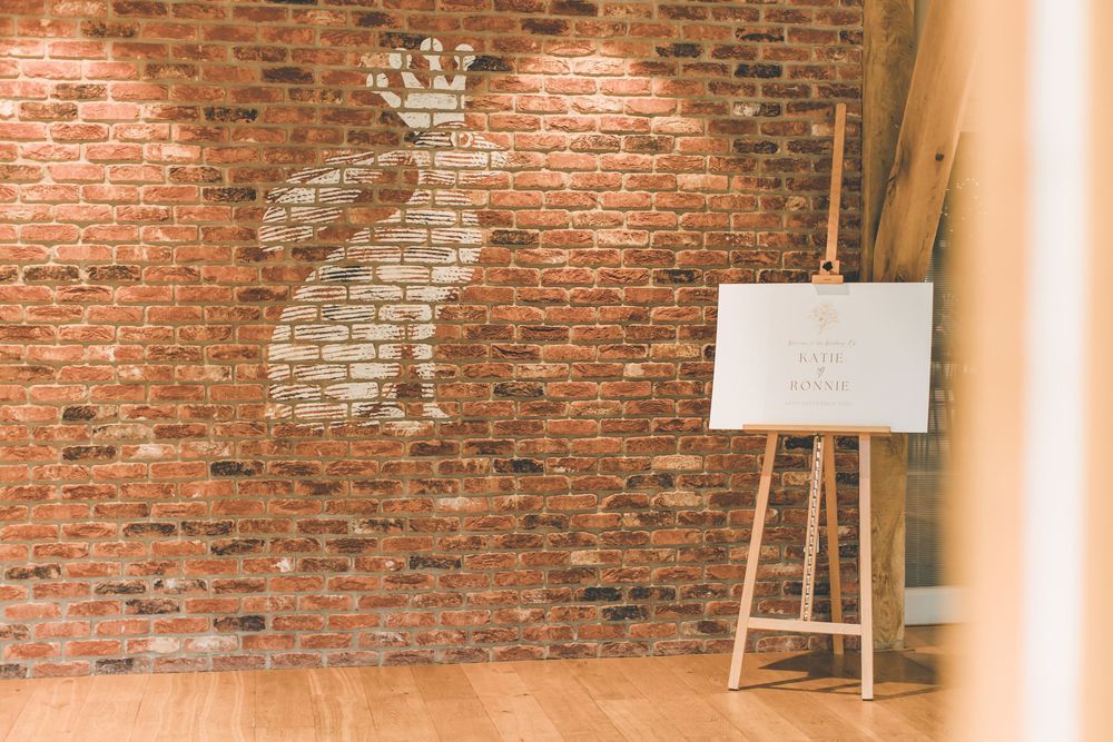 Interior detail of exposed brick wall at rustic wedding venue.