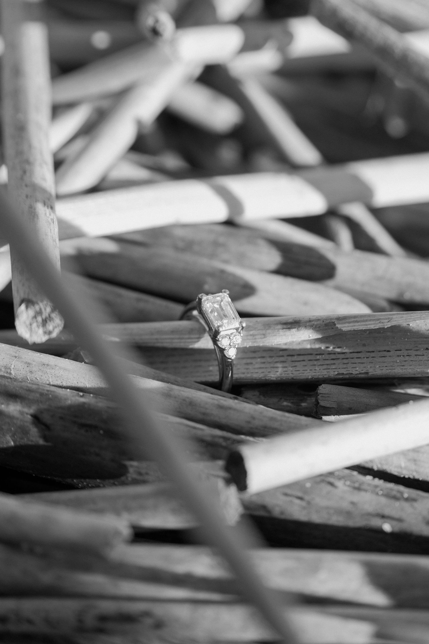 Artistic black and white macro photograph showing scattered wooden pencils with shallow depth of field.