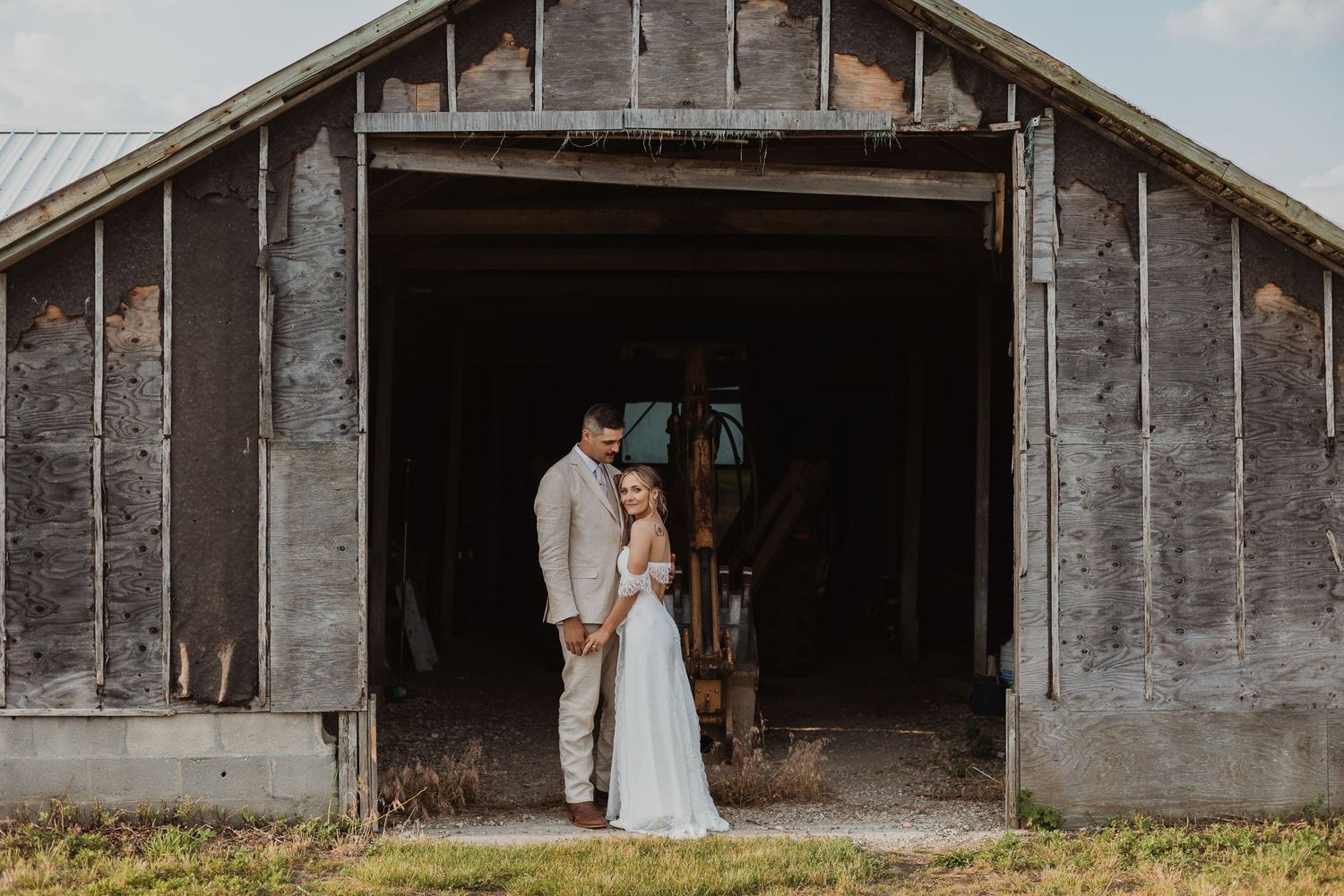 A series of rustic barn wedding photos showing couples in elegant attire against weathered wooden structures.