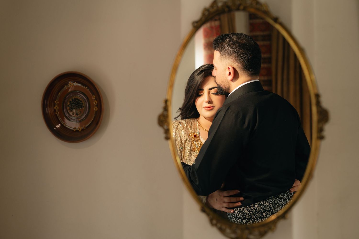 A series of romantic engagement photos captured in vintage mirrors with warm lighting and elegant decor.