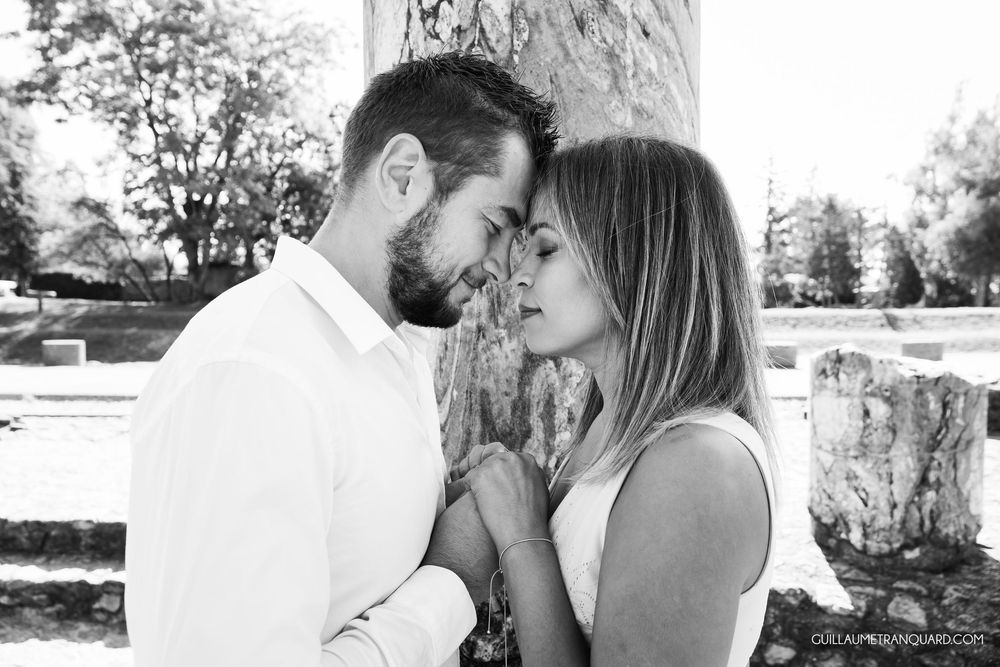 Romantic black and white photos of a couple sharing intimate moments outdoors.