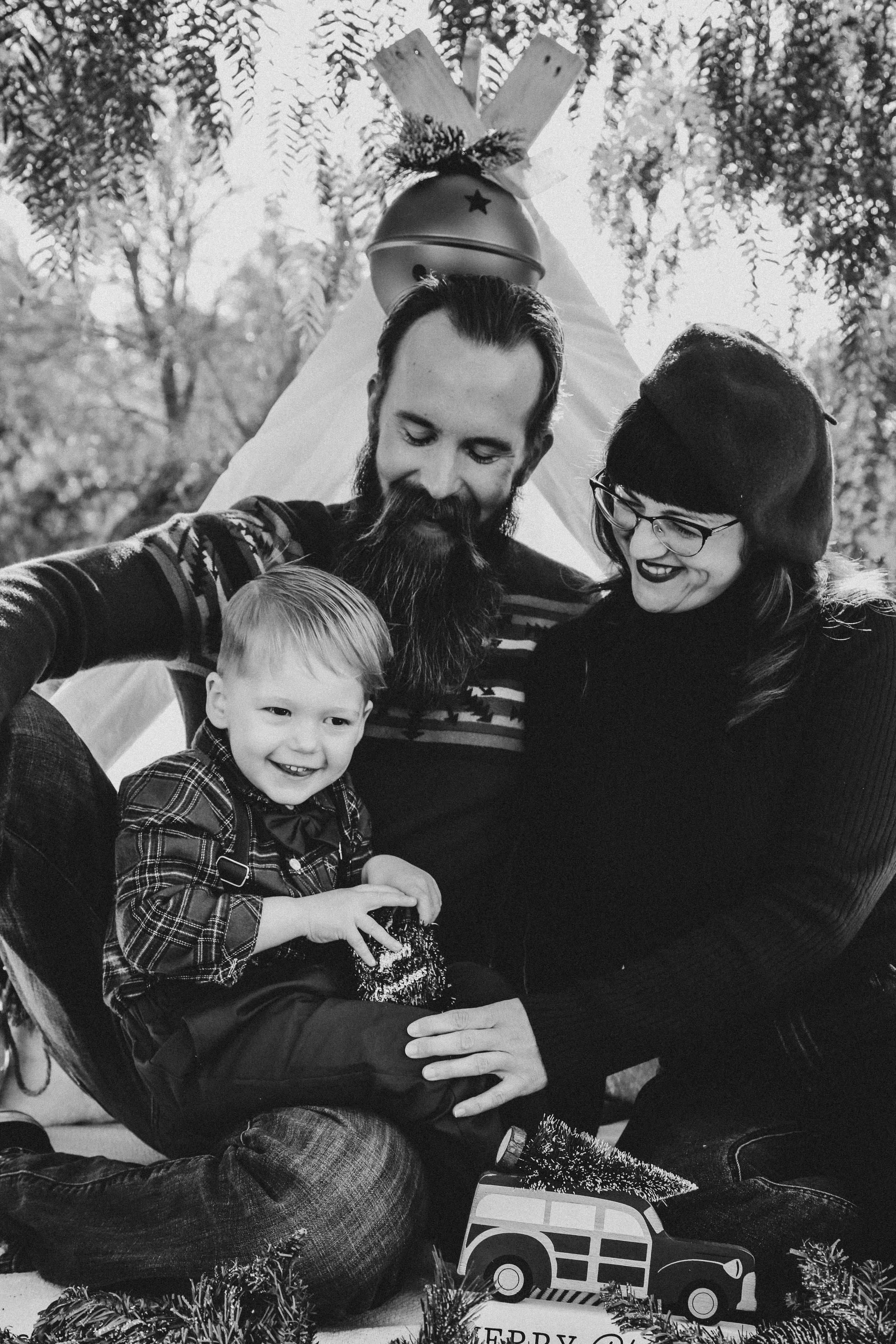 Black and white family photos showing intimate moments with toy train.