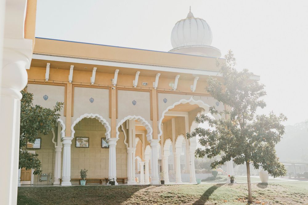 Exterior view of an elegant wedding venue with classic architecture and pillared design.