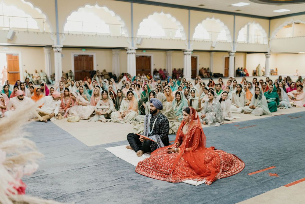 Panoramic view of wedding ceremony hall with guests seated on both sides.