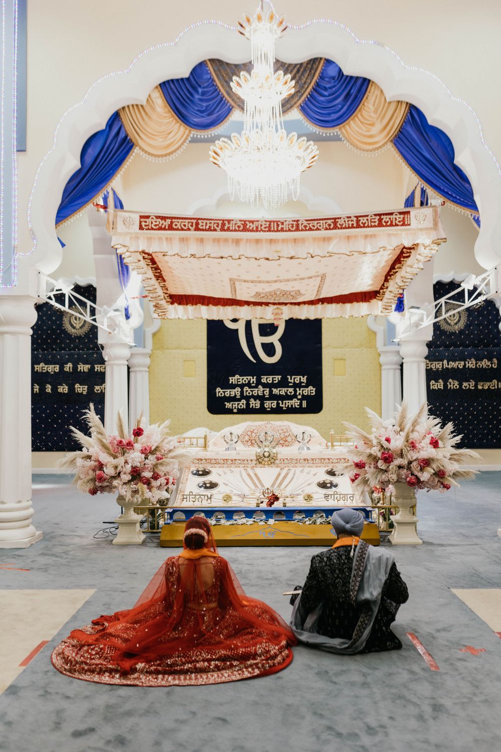 Ornate white and blue mandap setup for traditional Indian wedding ceremony.