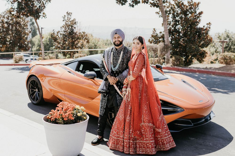 Orange luxury sports car decorated for Indian wedding celebrations.