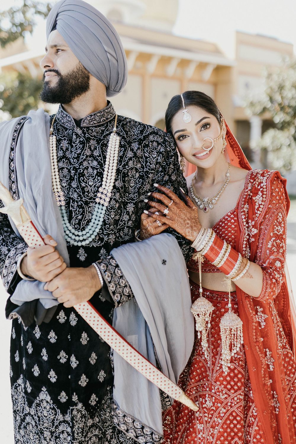 Romantic wedding portraits of a couple in traditional Sikh and Indian wedding attire with intricate details.