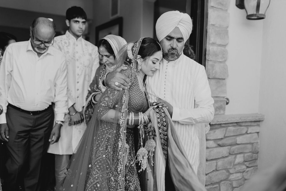 Wedding celebration candid moments with guests in traditional Indian formal wear.