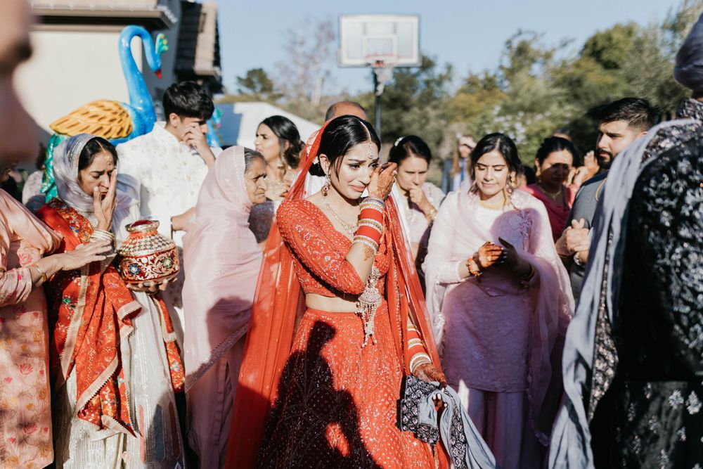 Traditional wedding guests in colorful festive attire gathered outdoors during celebration.