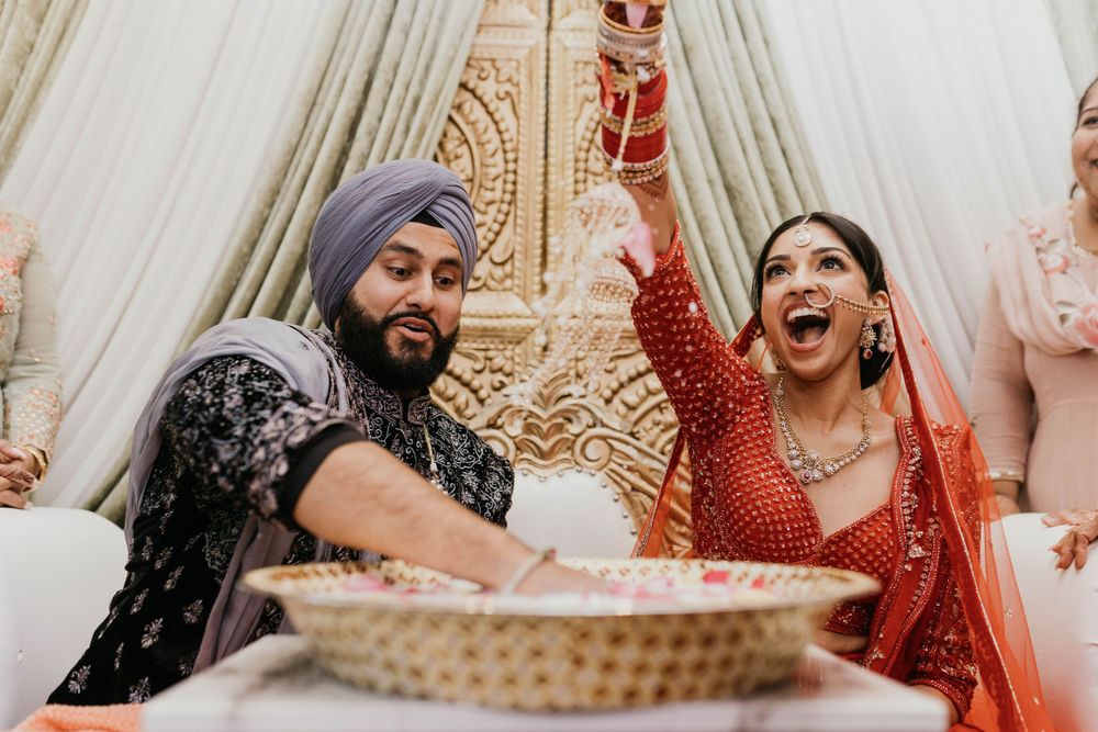 Joyful moments captured between couple in traditional Indian wedding attire.