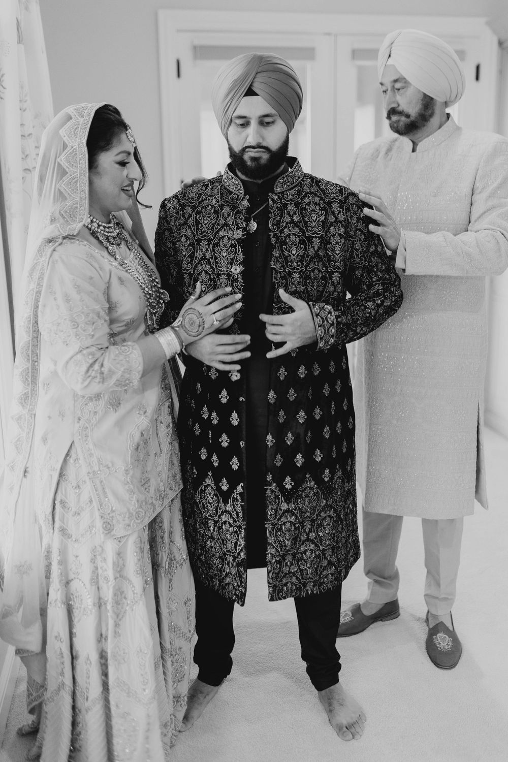 Black and white photo series capturing intimate moments during a traditional Sikh wedding ceremony.