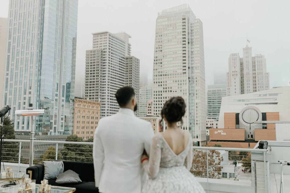 A beautiful rooftop wedding ceremony setup against a city skyline backdrop.