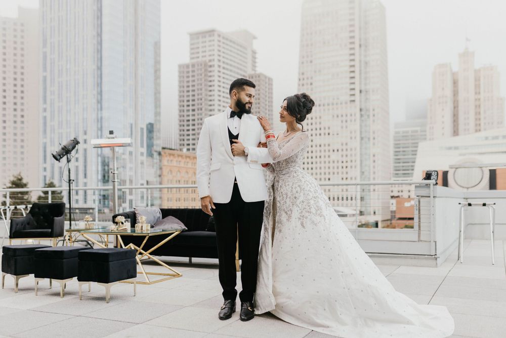 Elegant wedding reception setup on a city rooftop with stunning skyscraper views.