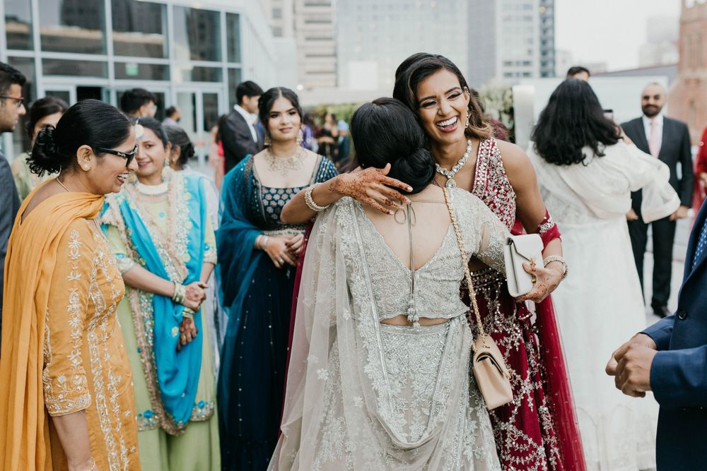 Wedding guests mingling at an elegant rooftop celebration in colorful attire.