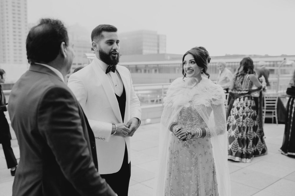 Black and white candid shots of wedding guests enjoying the celebration.