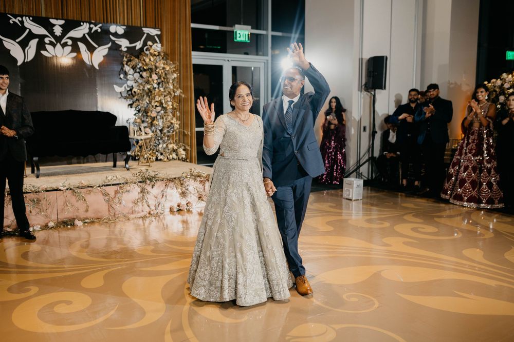 Spacious ballroom venue decorated with floral arrangements and warm lighting for wedding reception.