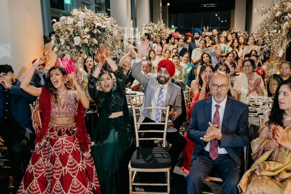 Wedding guests gathered in an elegant venue watching celebration on dance floor.
