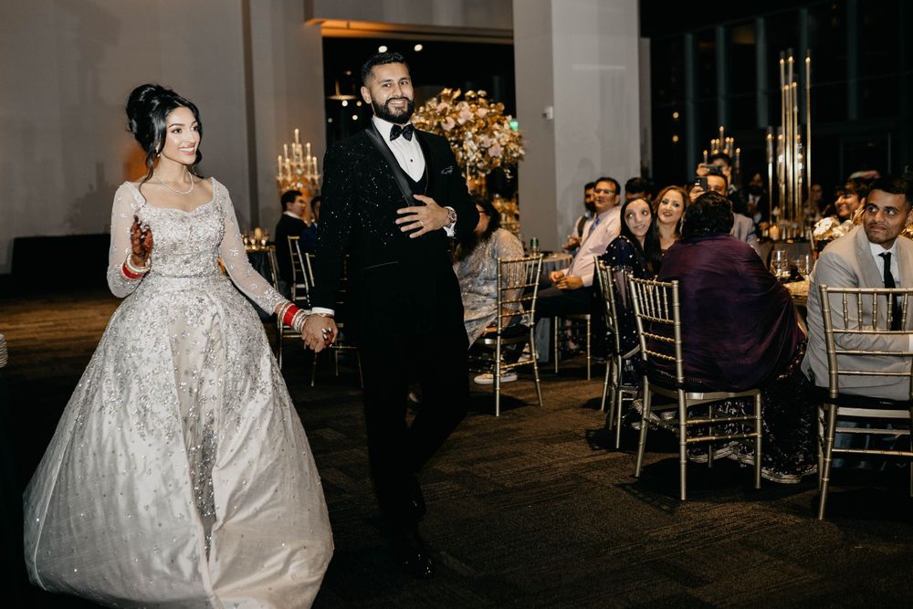 Elegant wedding venue with chandeliers and romantic mood lighting during evening celebration.