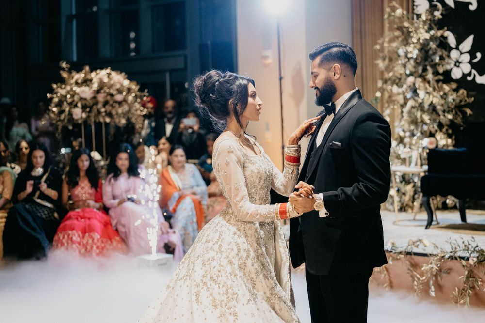 Romantic first dance moment captured in beautifully decorated wedding venue.