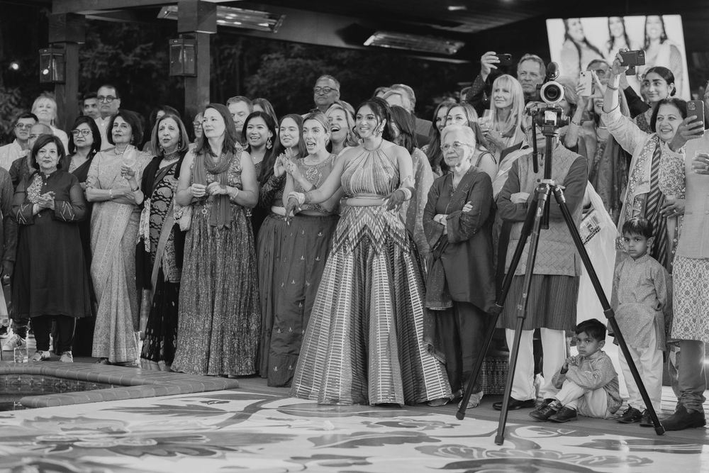 People dancing and enjoying themselves in black and white vintage-style reception photos.