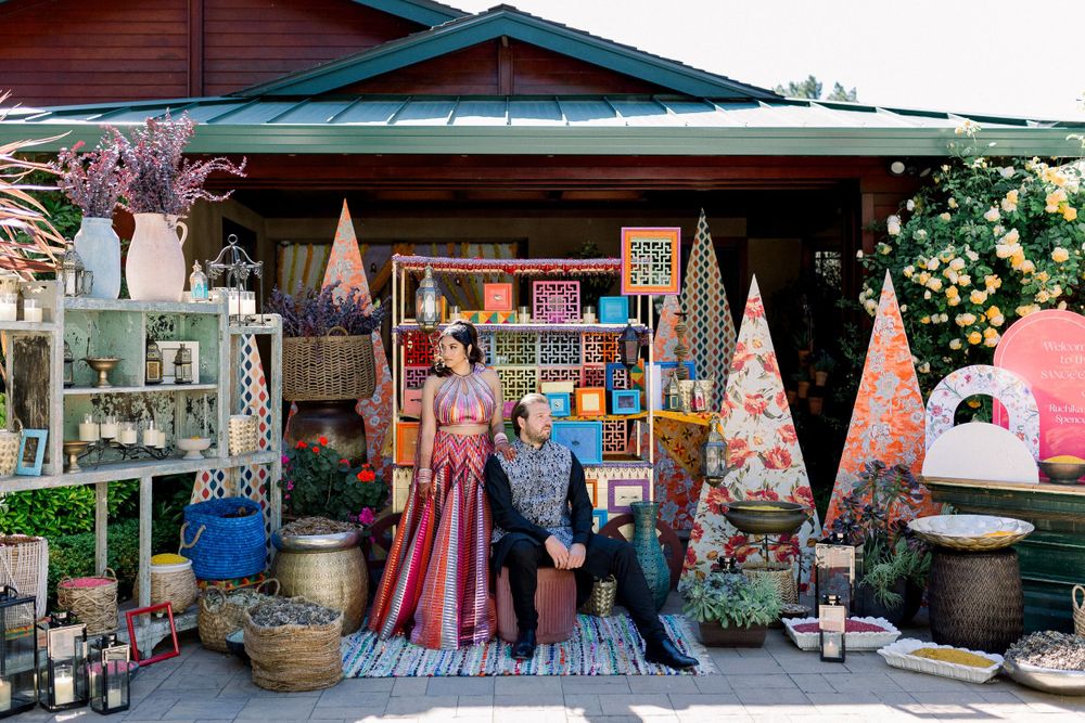 Exterior view of a colorful market stall with hanging textiles and decorative items.
