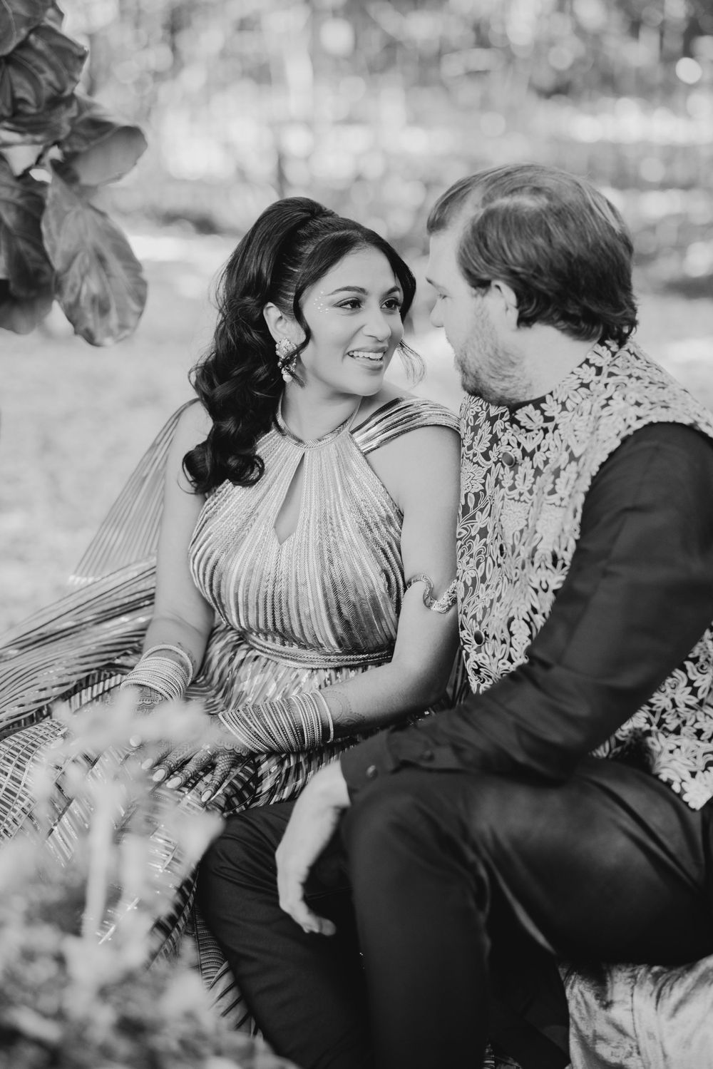 Black and white romantic couple's photoshoot showing tender moments in an outdoor setting.