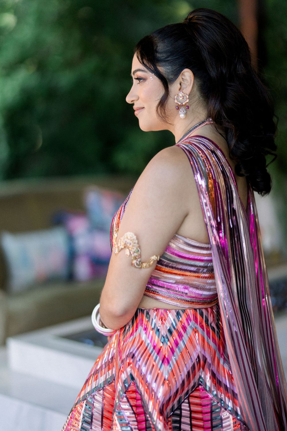 Close-up of a striped gown with purple and pink hues showing intricate back details.