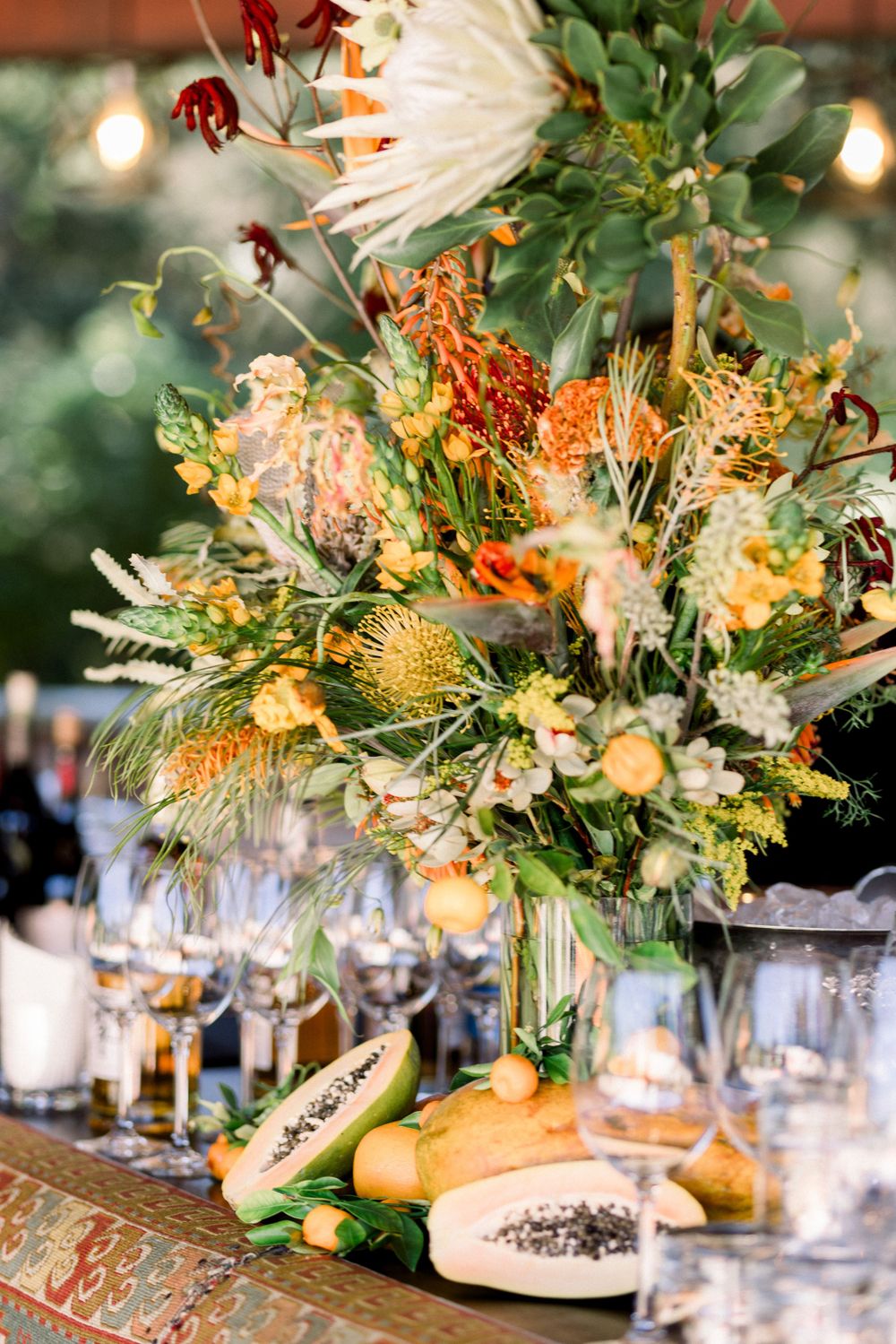 Elegant table settings with tropical floral centerpieces and glass stemware.