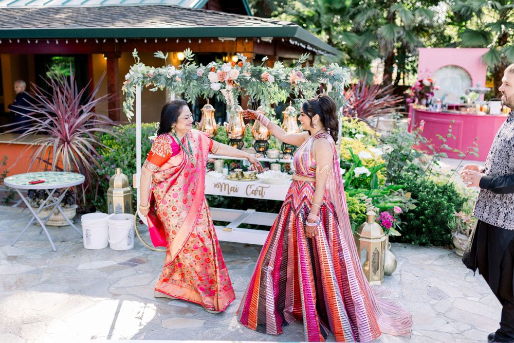 Garden party setup with colorful decorations and floral arrangements in an outdoor setting.