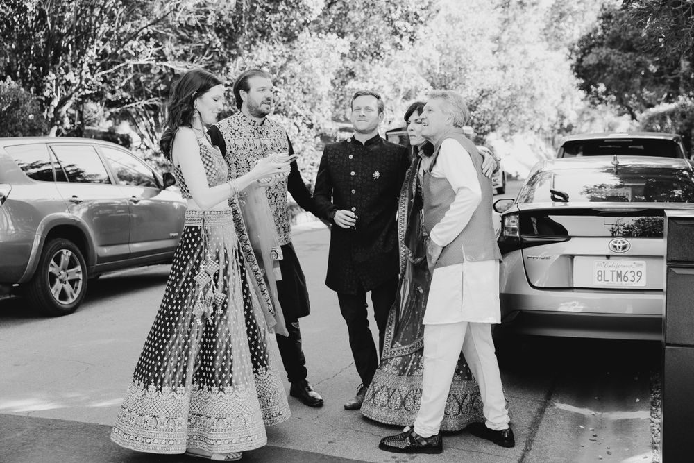 Black and white photo of guests arriving at outdoor celebration venue.