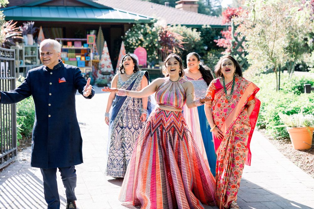 Outdoor walkway decorated for special celebration with guests in formal attire.