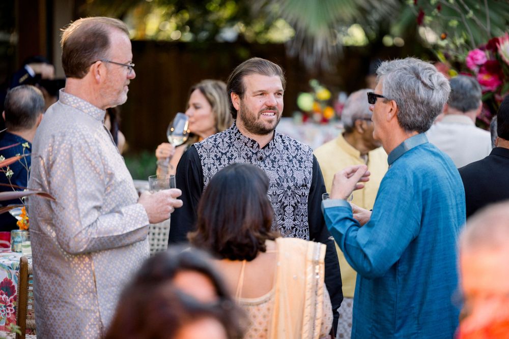 Group of guests mingling and socializing at an outdoor party event.