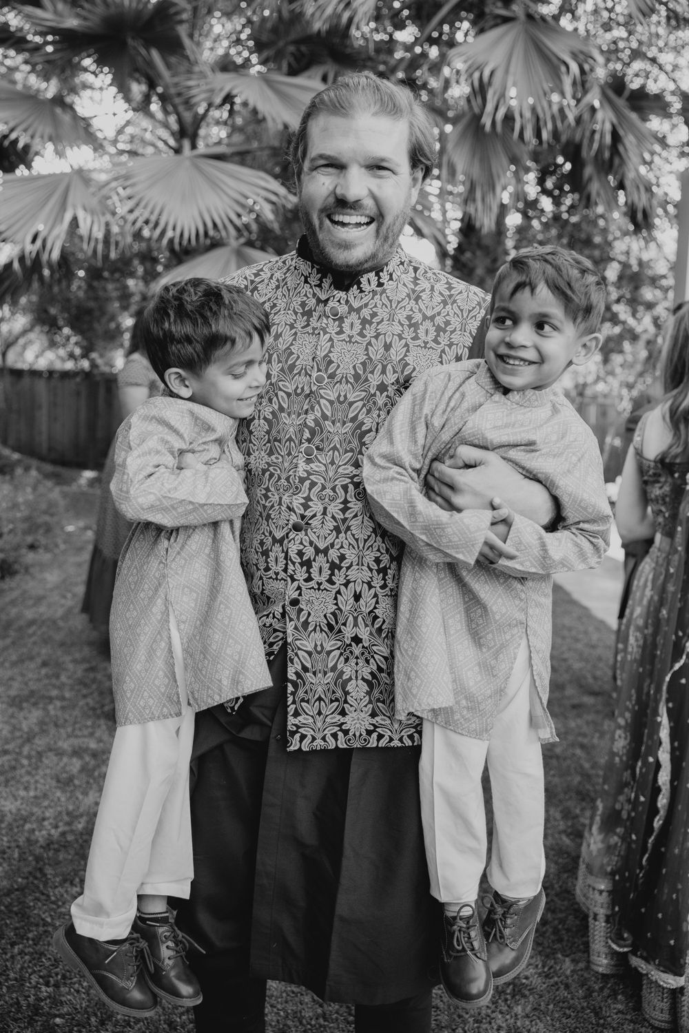 Family portrait in black and white featuring traditional Indian formal wear.