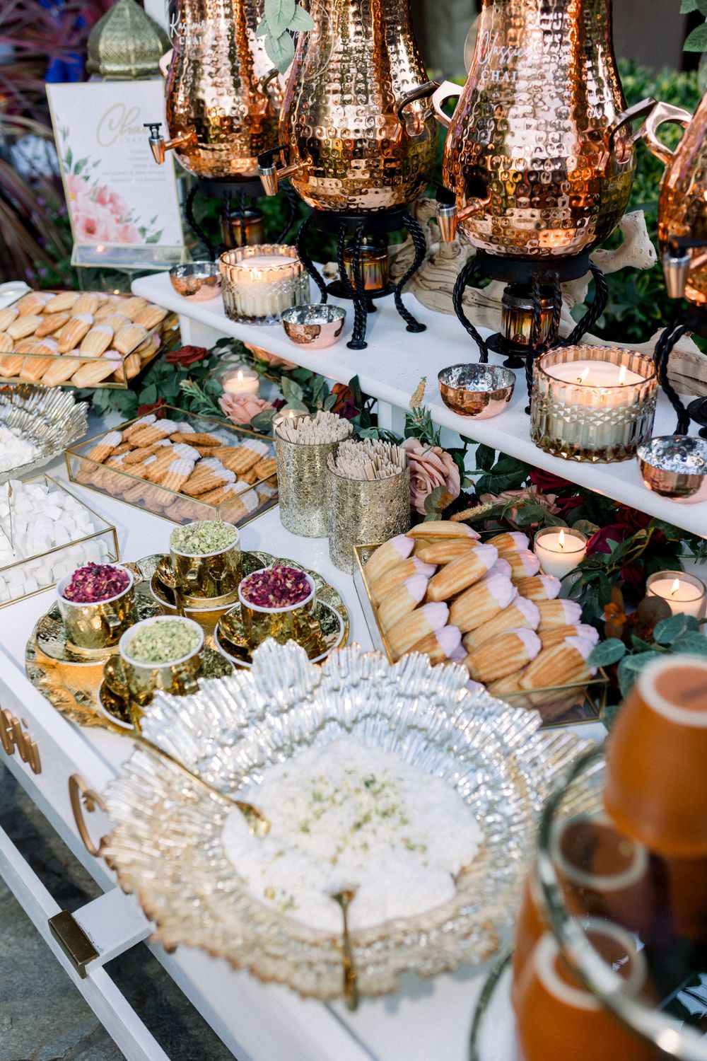 Elegant buffet spread with copper lanterns, appetizers and decorative platters.