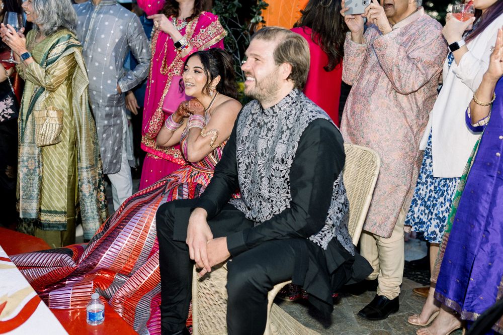 Energetic dance party with guests in traditional South Asian attire enjoying the celebration.