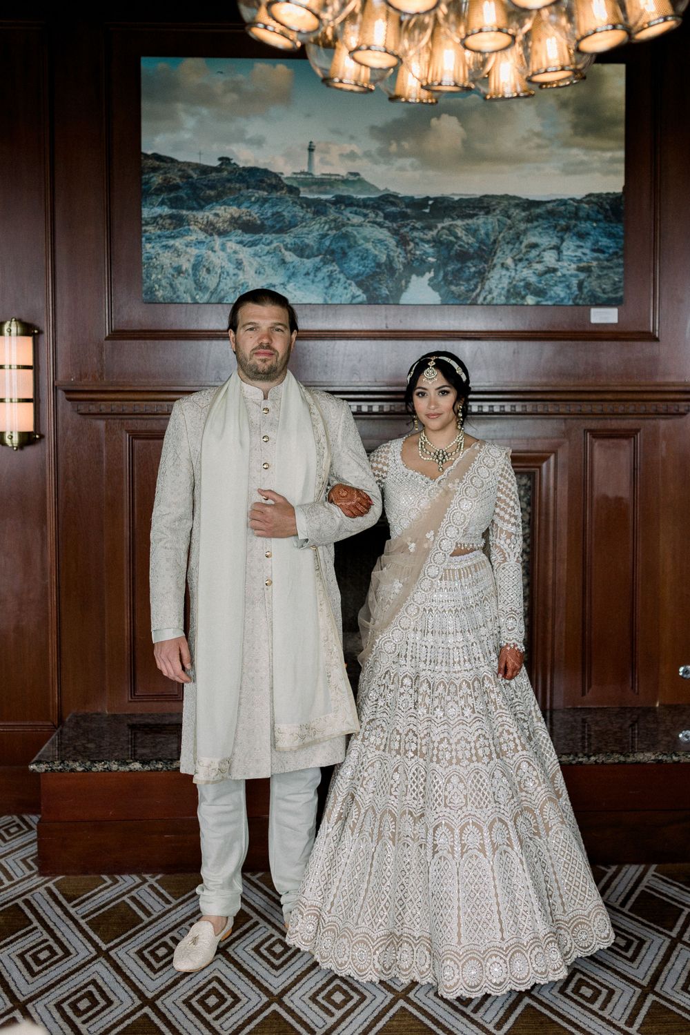Formal portrait session in an elegant wood-paneled room with dramatic lighting.