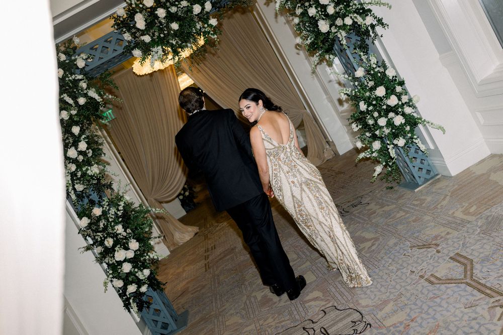 Wedding venue decorated with white floral arrangements and ambient lighting for an evening celebration.