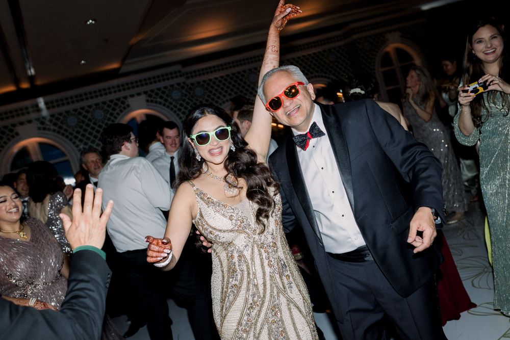 Guests dancing and celebrating at an elegant evening wedding reception.