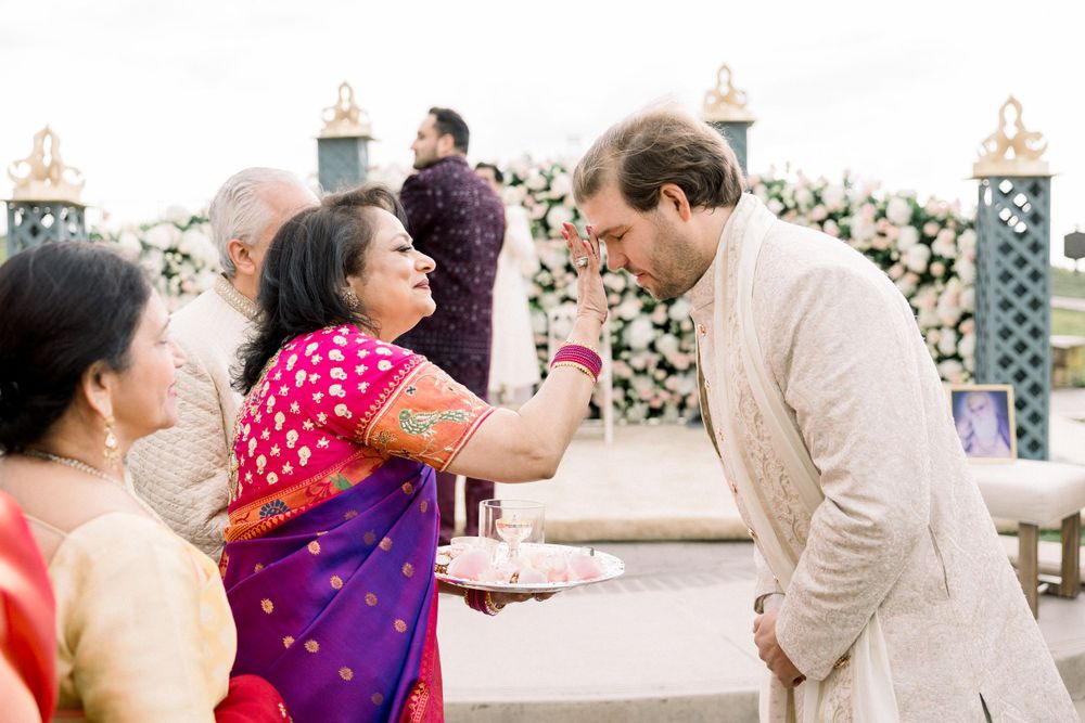 A couple shares a joyful moment during a traditional Indian wedding celebration.