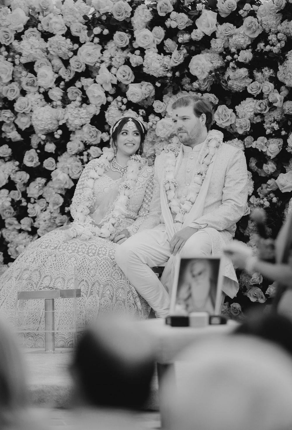 Wedding ceremony with floral decorations in black and white.