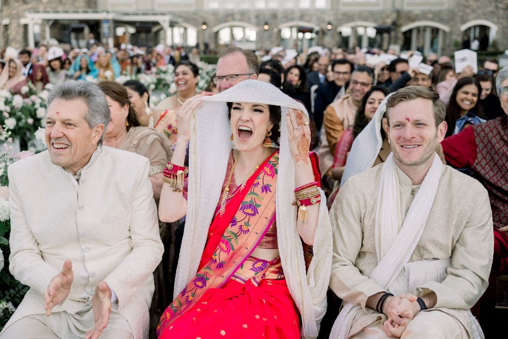 Guests celebrating at outdoor wedding with floral decorations.