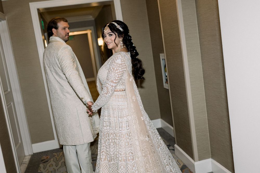 Candid wedding photos captured in a modern hotel hallway.