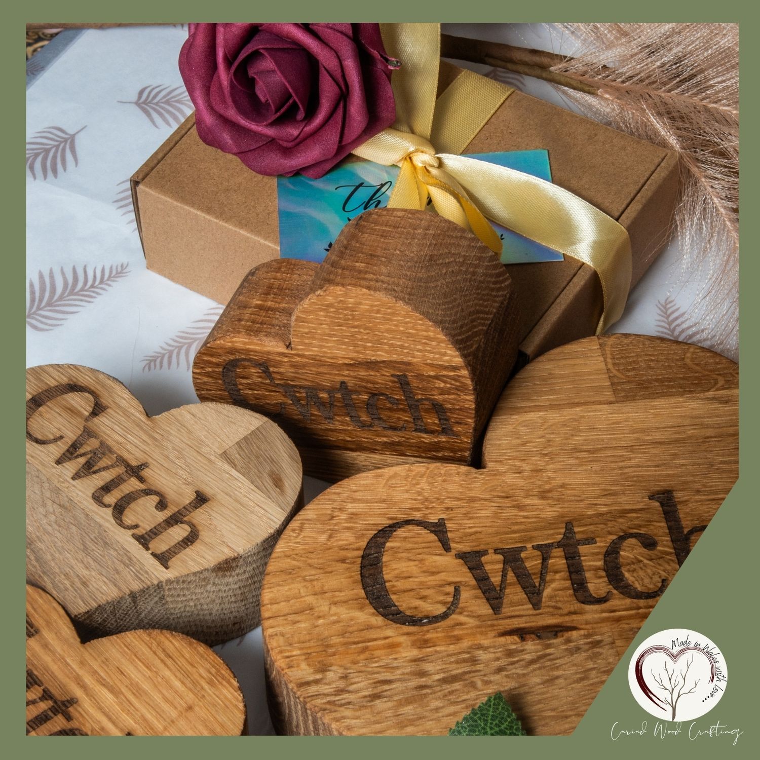 Wooden crafted pieces with text engravings alongside decorative elements and gift packaging.