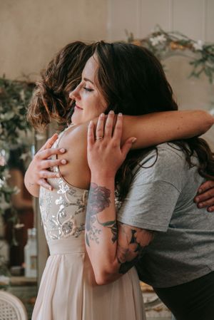 An emotional embracing moment captured during wedding preparations.