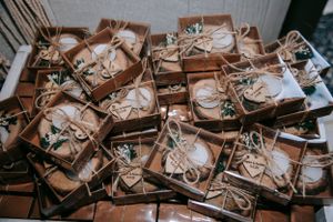 Rustic wooden gift boxes with twine bows arranged in rows.